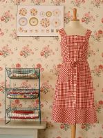 View of mannequin with a gingham dress beside side table