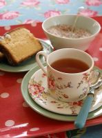 Tea cup and spoon with cake and bowl