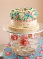 View of flowers in bowl with cake close-up