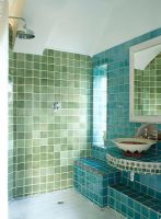 Tiled bathroom with sink and shower  