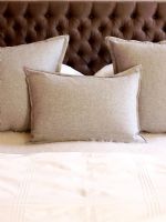 Soft grey cushions on bed