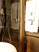 Detail of towel rail and shower in modern bathroom