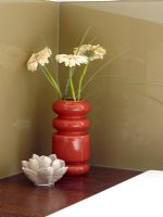 Gerberas in vase in modern bathroom