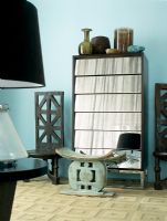 Ethnic stool and mirrored cupboard