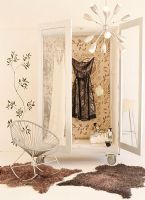 Dress hanging in wardrobe beside rocking chair