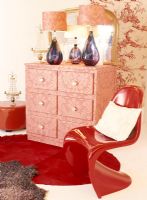 Red Panton chair beside cupboard
