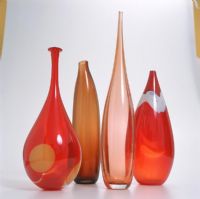 A collection of red glass vases