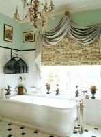 Traditional bathroom with bathtub beside window