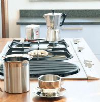 Stove top with coffee pot and silver cup