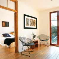 Two contemporary armchairs near  bedroom door