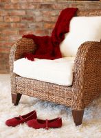 Wicker armchair with red shoes 