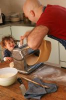 Father and son with pasta maker