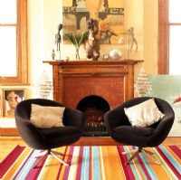 Colorful carpet with two vintage chairs and fireplace