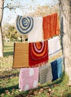 A collection of rugs hanging on a clothesline