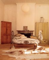 Spacious bedroom with pet dog on a cow skin rug