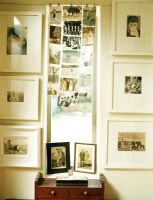 Photographs on wall with side table