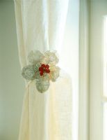 Close-up of a beaded flower curtain tie back