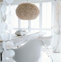 Chairs and a dining table with a fur covered hanging lamp