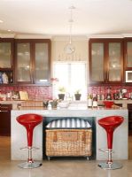 View of modern kitchen with red stools