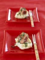 Seared tuna and mash on a red plate