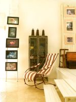 A striped armchair and display of photos