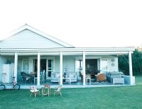 Traditional home with lawn and garden furniture