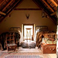 An attic bedroom with animal skin throws
