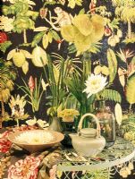 Floral print wallpaper and a table with houseplants