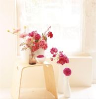 A collection of flower bouquets on a wooden stool