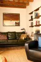 Living room with leather sofa and built in bookshelves