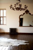 Hide rug and stained wooden floors