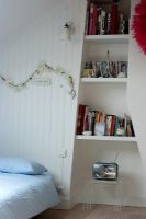 Shelves in alcoves of contemporary bedroom
