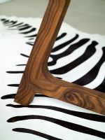 Detail of chair leg and modern black and white zebra print rug
