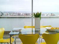 Glass dining table and yellow Jacobsen Series 7 chairs