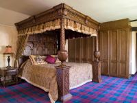 Traditional bedroom with tartan carpet and four poster bed