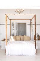 Modern bedroom with wooden four poster bed