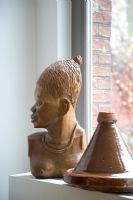 Wooden african sculpture and pot detail 