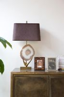 Lamp and photographs on living room unit