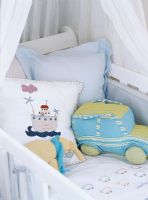 Cushions and toy in crib