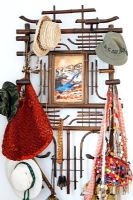 Hats and bags on wall mounted hooks
