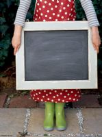 Close up of woman holding blackboard