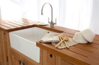 Butler sink in modern wooden kitchen 