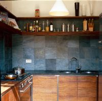 Modern kitchen with stone tiled wall