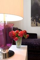 Lamp and flowers on side table