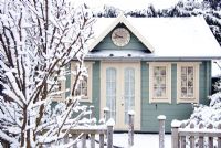 Country summerhouse exterior in the snow