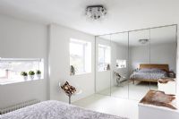 Mirrored wardrobe in modern bedroom 