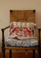 Embroidered cushion on country style chair