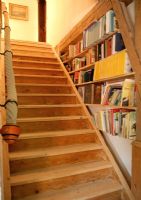 Wooden staircase with bookshelves 
