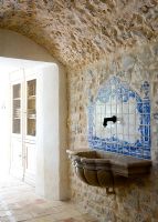 Decorative splashback tiles above marble sink