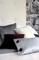 Close up of cushions on bed 